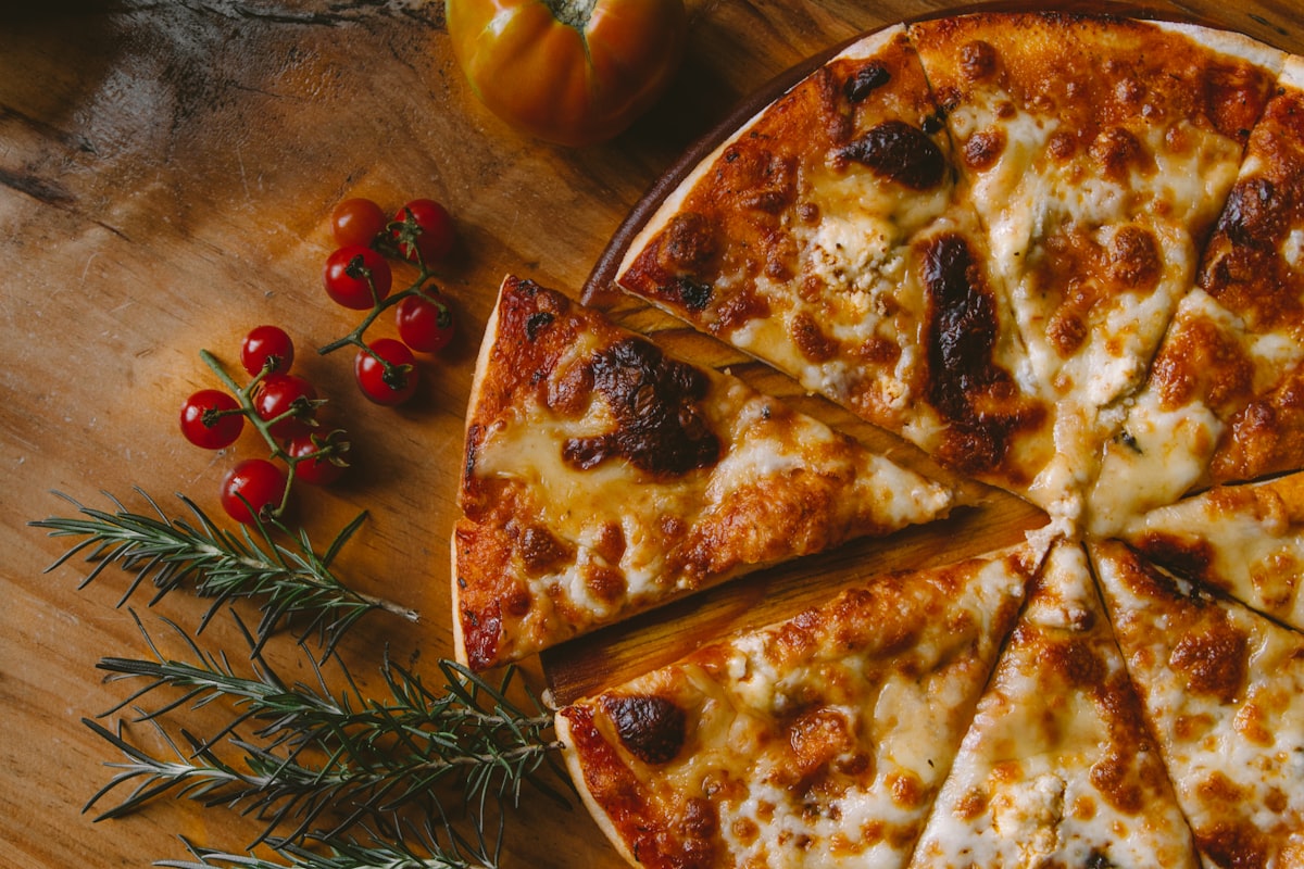 Fresh pizza coming out of the oven